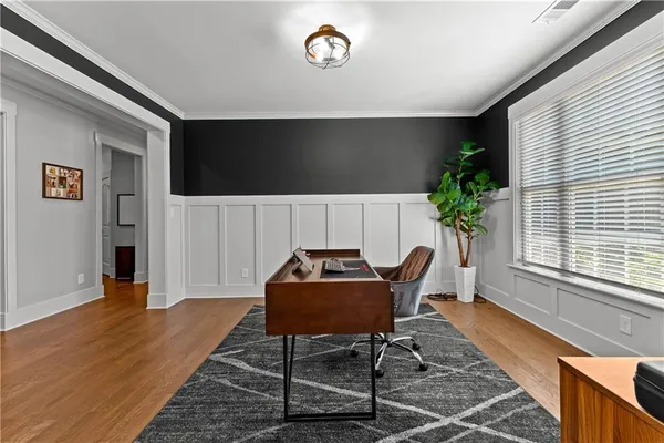 a bedroom with a large bed and a chandelier fan