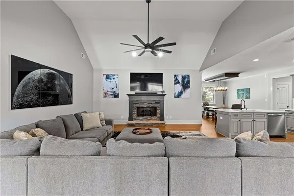 a living room with furniture and kitchen view