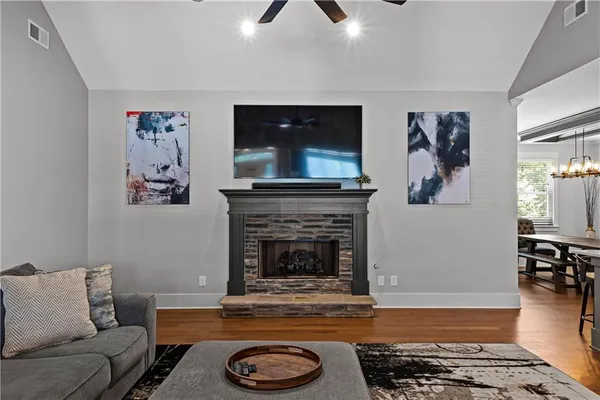 a living room with furniture a flat screen tv and a fireplace