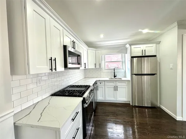 a kitchen with a refrigerator stove and sink