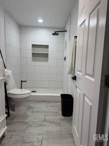 a bathroom with a toilet a sink and a shower