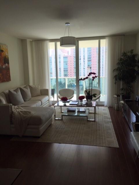 3340 Northeast 190th Street, Unit 1105 Miami, FL 33180 - Photo 7 of 17 a living room with furniture and a large window