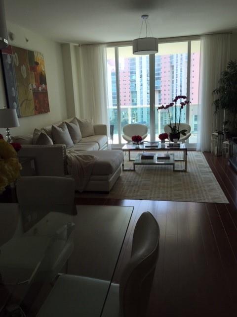 3340 Northeast 190th Street, Unit 1105 Miami, FL 33180 - Photo 8 of 17 a living room with furniture and a large window