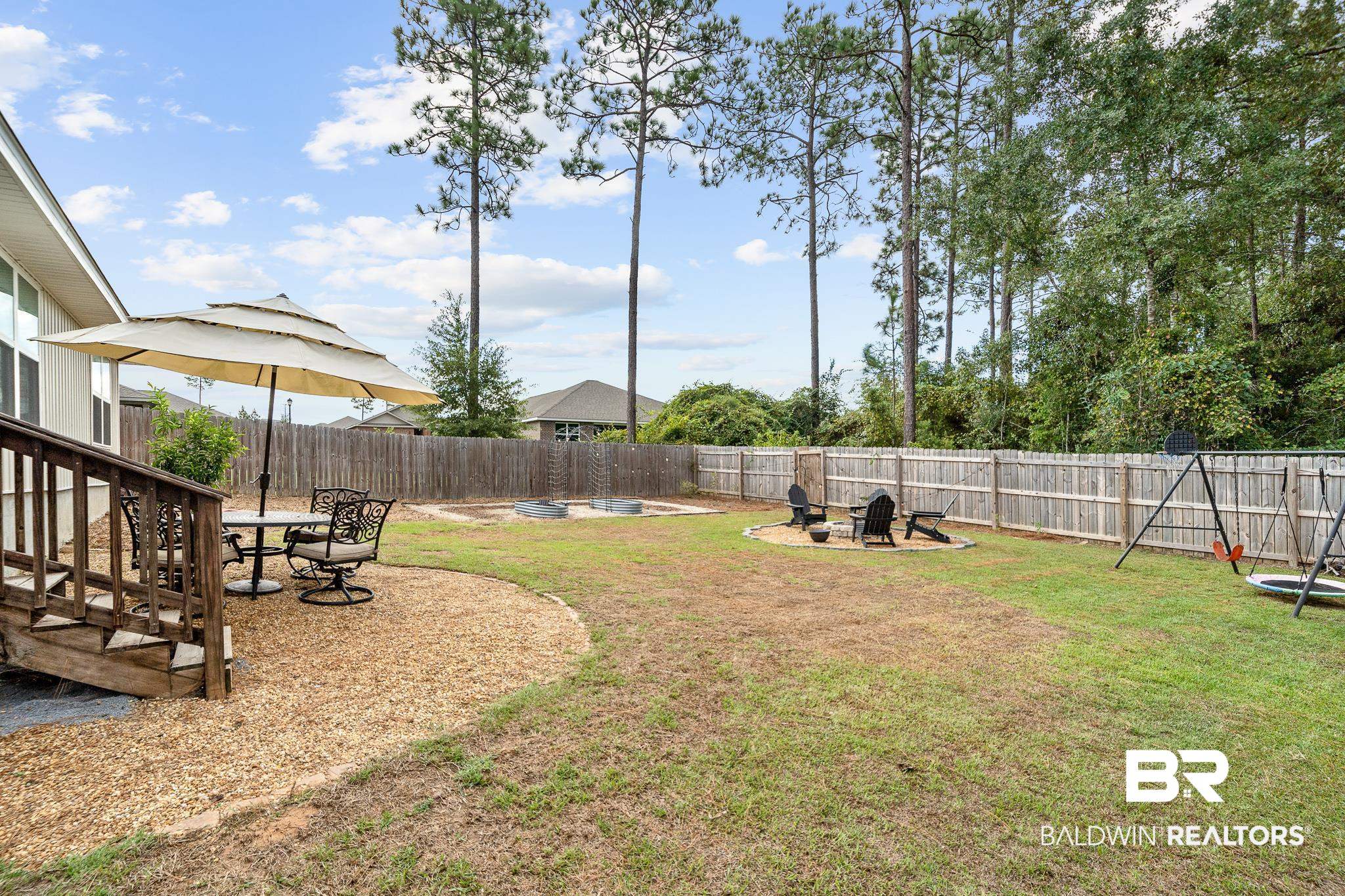 10516 Brodick Loop Daphne, AL 36527 - Photo 24 of 27 View of yard featuring a patio and an outdoor fire pit