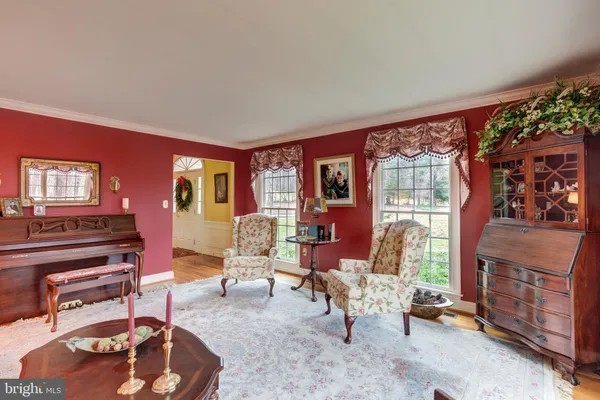 a living room with furniture a rug and a chandelier
