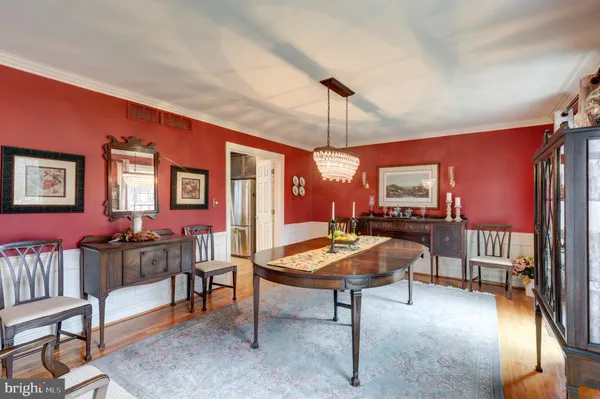 a view of a living room and a livingroom with furniture wooden floor a fireplace