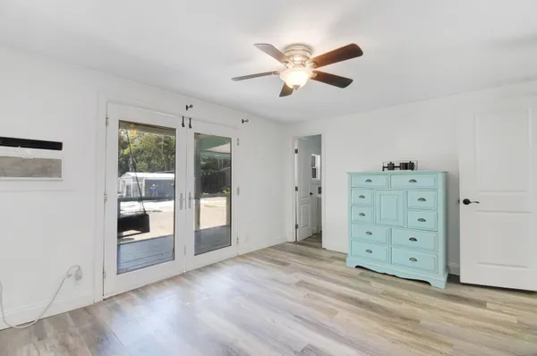a view of a livingroom with wooden floor closet and windows