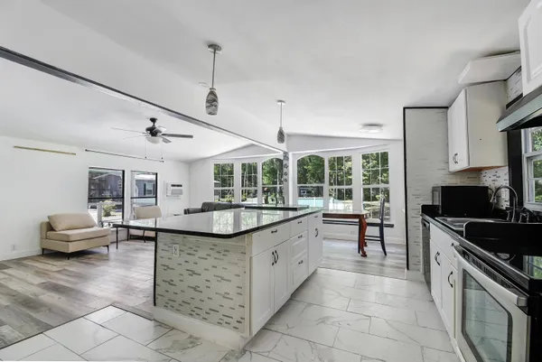 a kitchen with stainless steel appliances granite countertop a sink and a stove