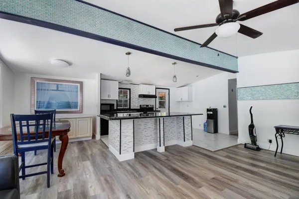 a kitchen with a wooden floor and a refrigerator
