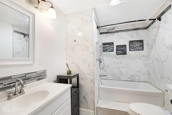 a bathroom with a sink toilet and shower