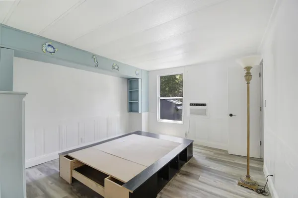 a room with a bed and a window