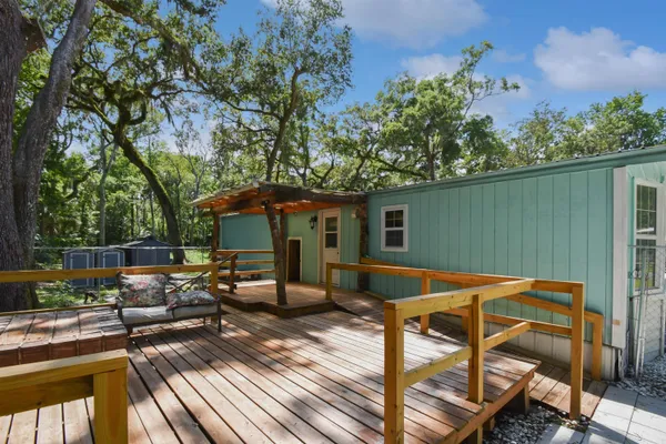 a view of backyard with seating space and trees