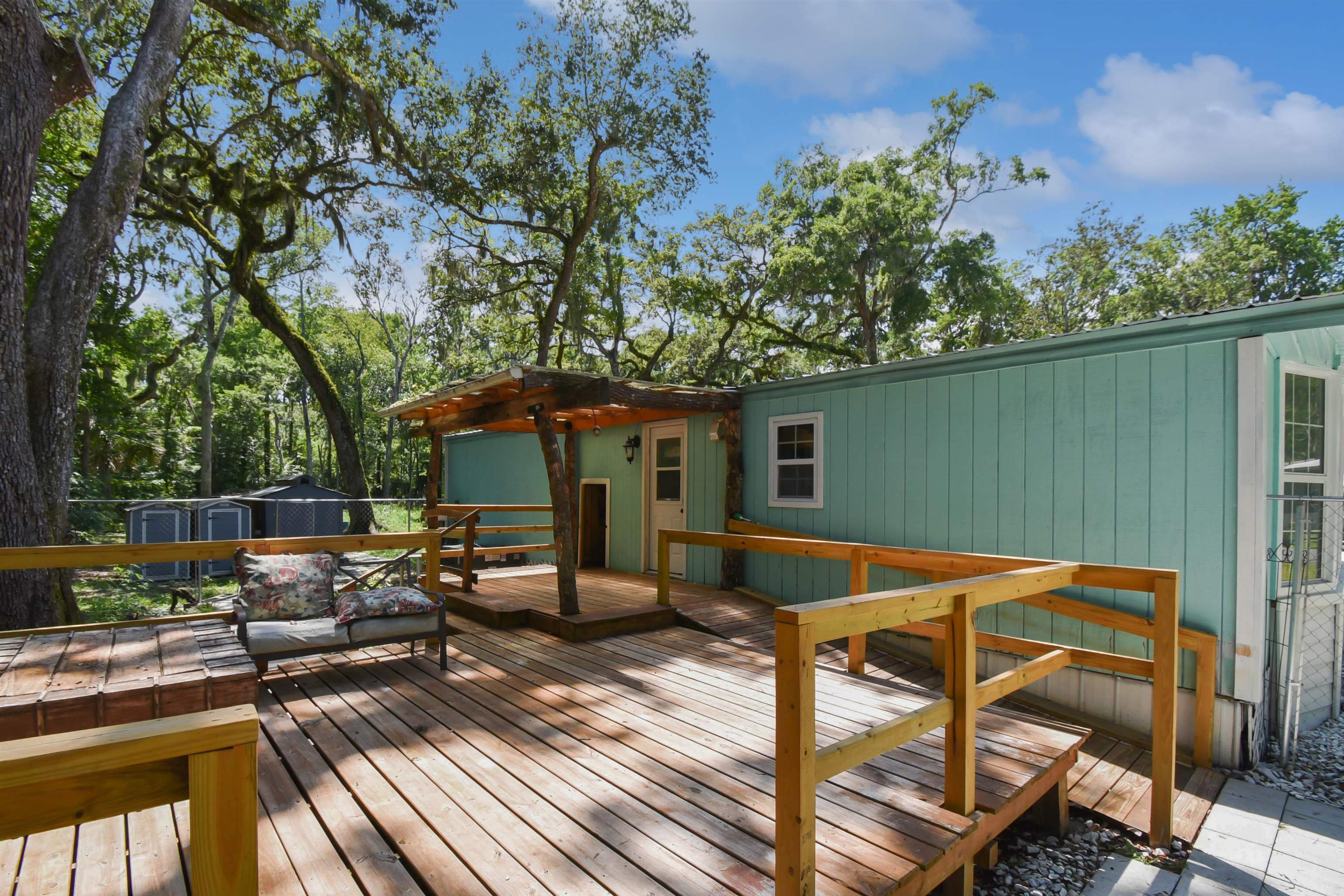 4895 Ave D St. Augustine, FL 32095 - Photo 6 of 25 a view of backyard with seating space and trees