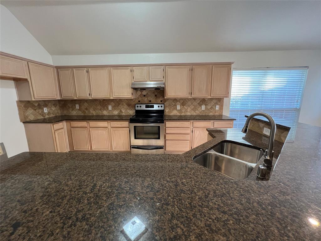334 Touchdown Drive Irving, TX 75063 - Photo 12 of 32 Kitchen featuring extensive counter space with a built-in double basin sink and gooseneck faucet