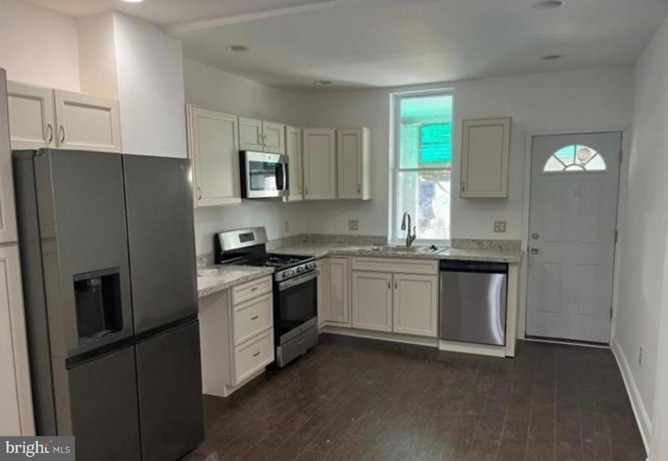 1234 North 56th Street Philadelphia, PA 19131 - Photo 1 of 31 a kitchen with stainless steel appliances granite countertop a refrigerator sink and stove