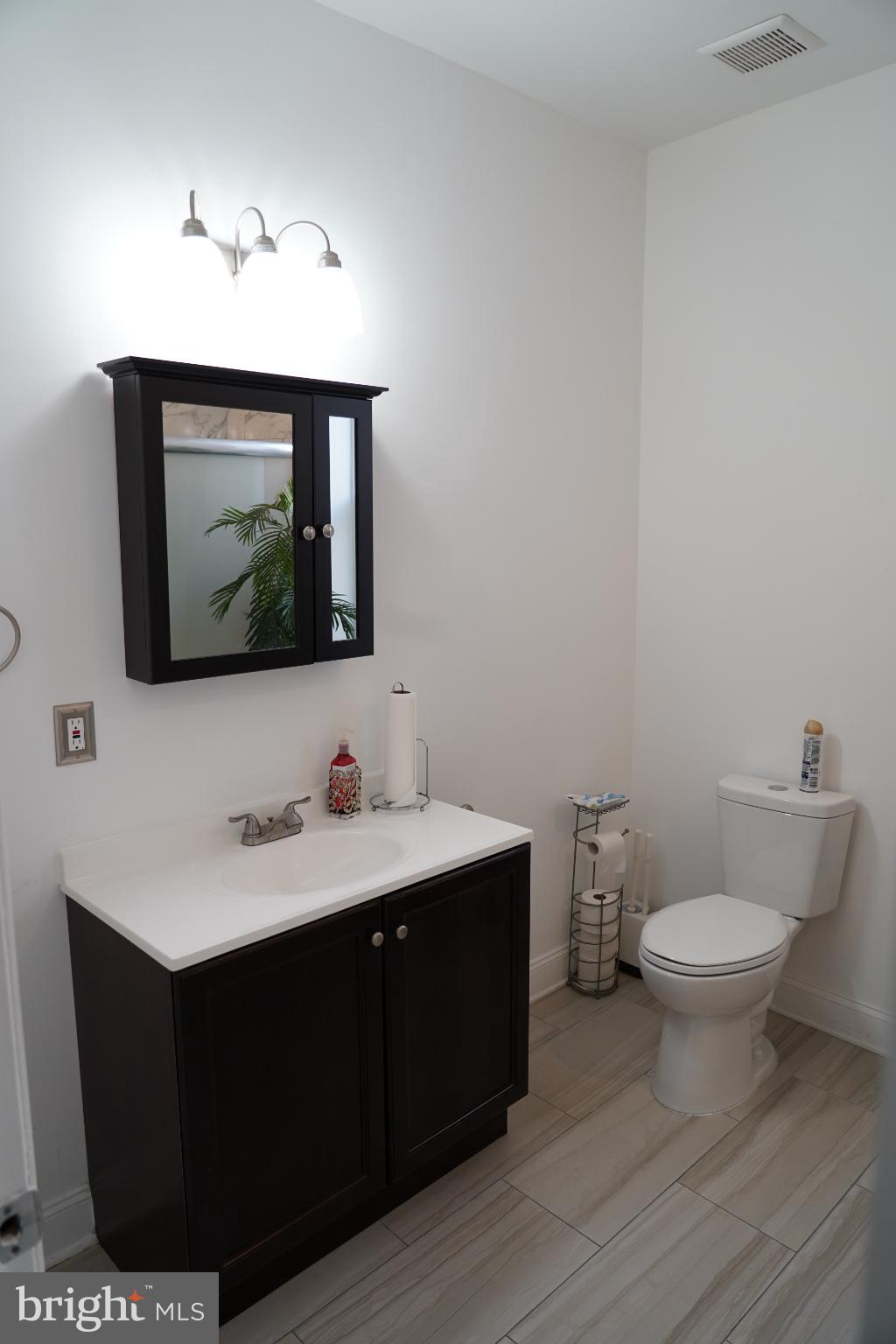 1234 North 56th Street Philadelphia, PA 19131 - Photo 18 of 31 a bathroom with a toilet sink and mirror