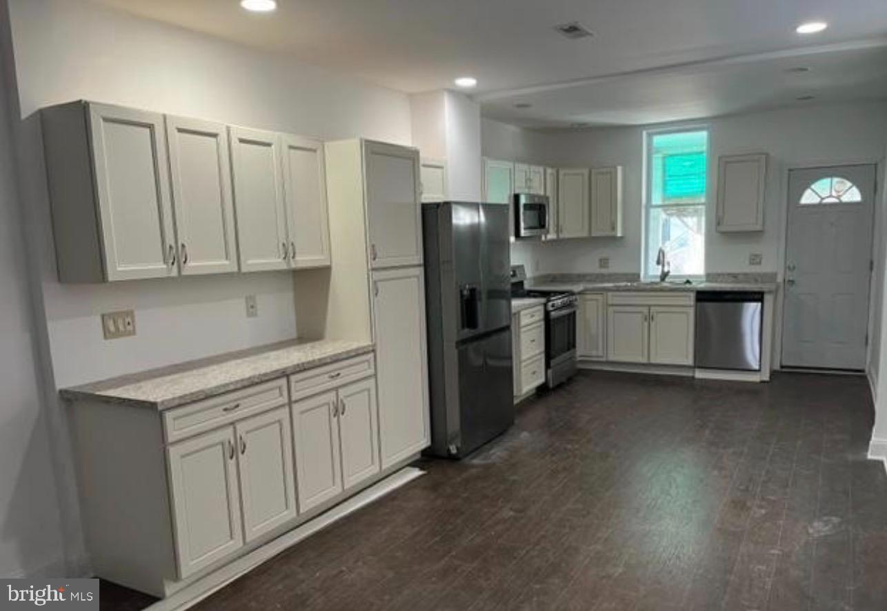 1234 North 56th Street Philadelphia, PA 19131 - Photo 2 of 31 a kitchen with stainless steel appliances granite countertop a refrigerator sink and stove