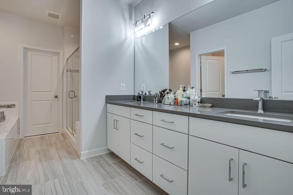 518 Triggerfish Drive Oxon Hill, MD 20745 - Photo 19 of 35 a bathroom with a double vanity sink and mirror