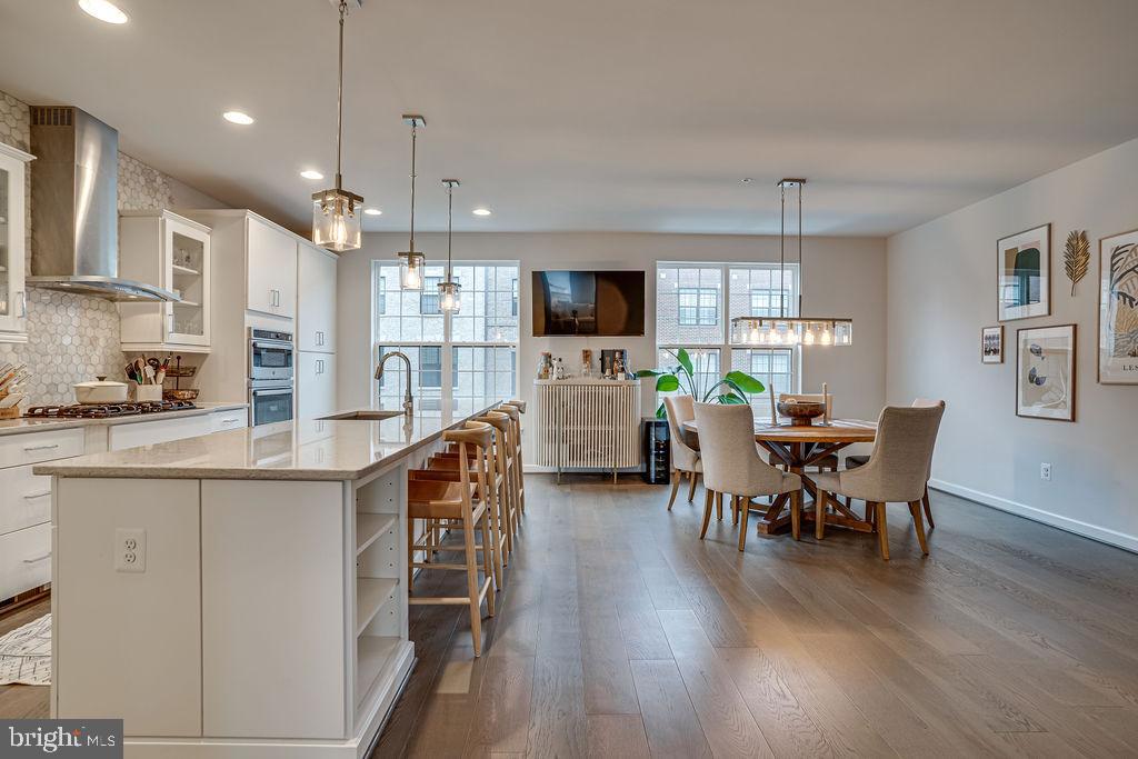 518 Triggerfish Drive Oxon Hill, MD 20745 - Photo 6 of 35 a kitchen with stainless steel appliances granite countertop table chairs refrigerator and microwave