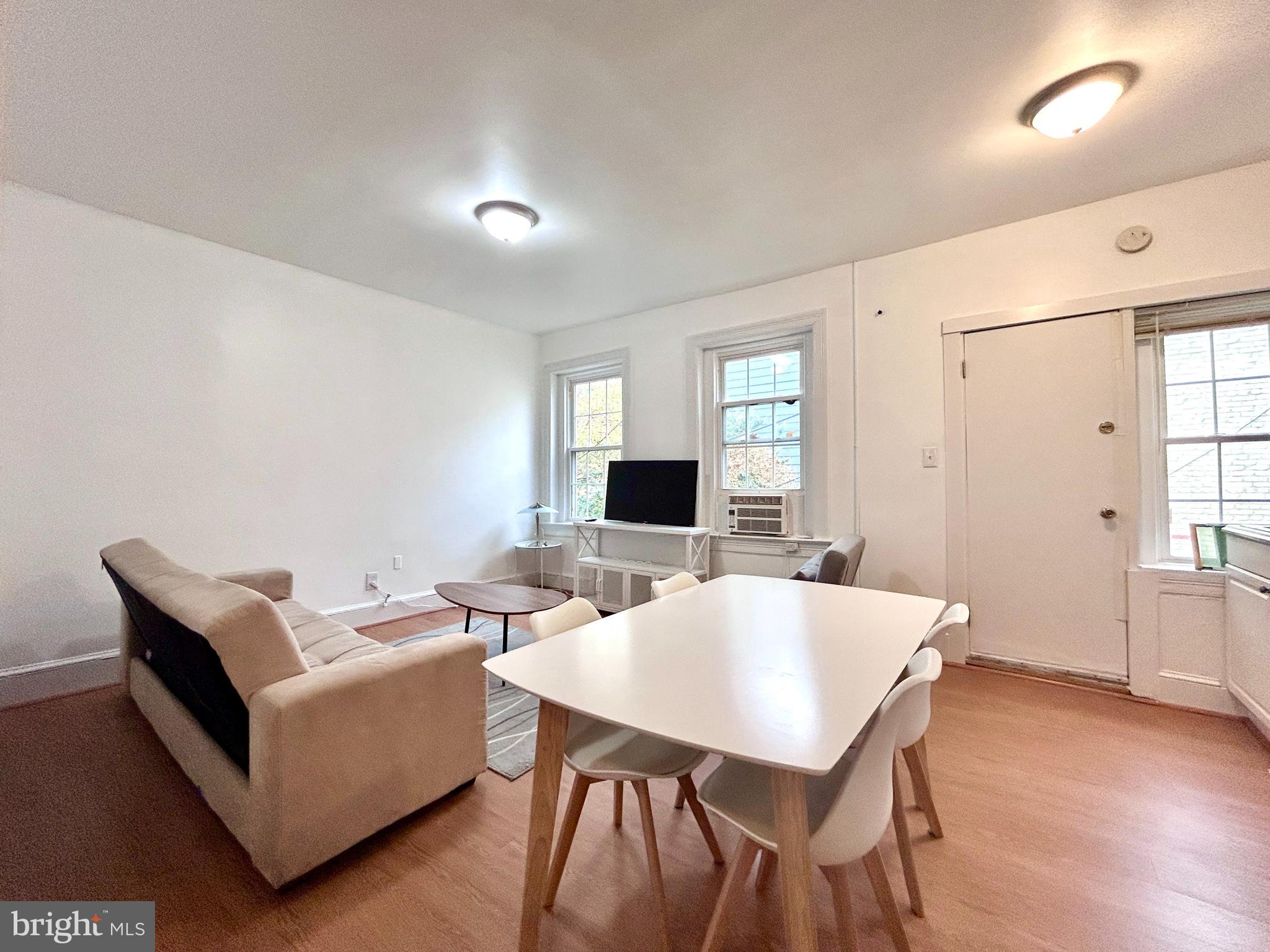 1544 Independence Avenue Southeast, Unit 3 Washington, DC 20003 - Photo 3 of 10 a living room with furniture and a wooden floor
