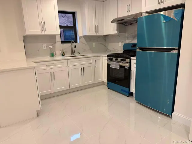 a kitchen with a refrigerator and a sink