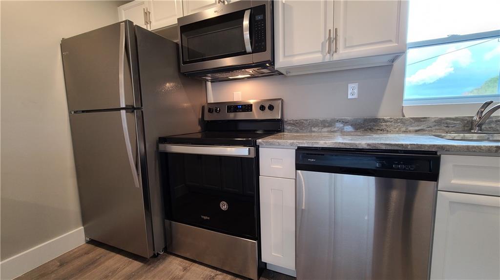 1331 Freeport Road Cheswick, PA 15024 - Photo 4 of 32 a kitchen with stainless steel appliances granite countertop a refrigerator and a stove top oven