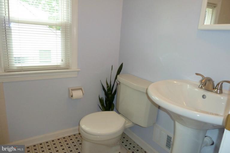1603 Moffet Road Silver Spring, MD 20903 - Photo 13 of 30 a white toilet sitting next to a bathroom sink