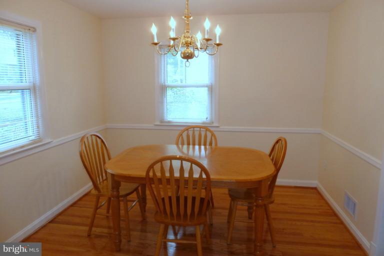 1603 Moffet Road Silver Spring, MD 20903 - Photo 19 of 30 a view of a dining room with furniture a chandelier and wooden floor