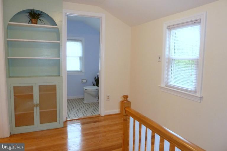 1603 Moffet Road Silver Spring, MD 20903 - Photo 4 of 30 a view of a hallway with wooden floor and a living room