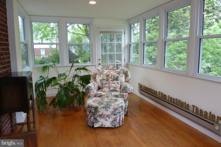 1603 Moffet Road Silver Spring, MD 20903 - Photo 10 of 30 a living room filled with furniture and a floor to ceiling window