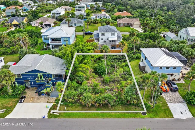 an aerial view of multiple houses with yard