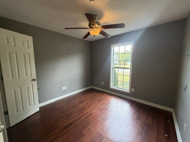 515 Preakness Circle Pleasant View, TN 37146 - Photo 10 of 13 an empty room with wooden floor fan and windows