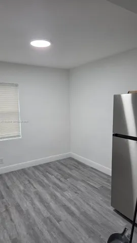 a view of a refrigerator in kitchen and wooden floor