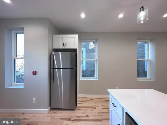 a kitchen with stainless steel appliances granite countertop a refrigerator and a sink