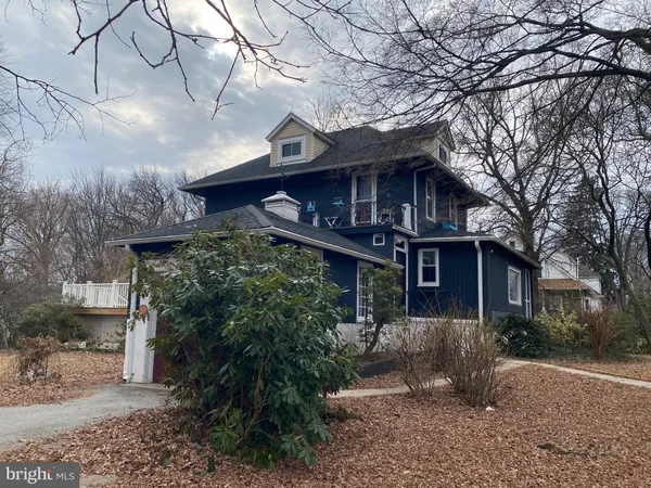 a house view with a tree in front of it