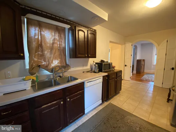 a large kitchen with a large window and stainless steel appliances