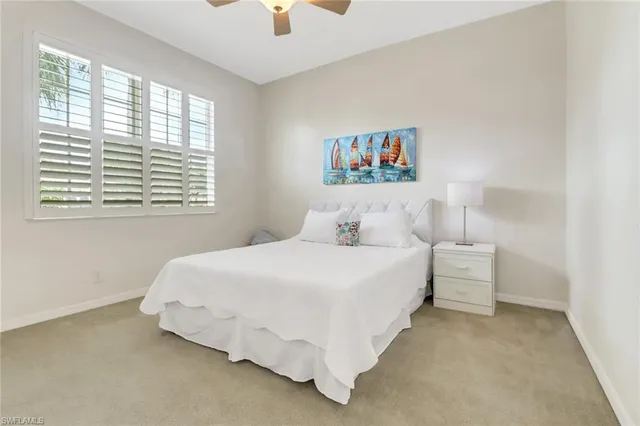 a spacious bedroom with a bed and a chandelier