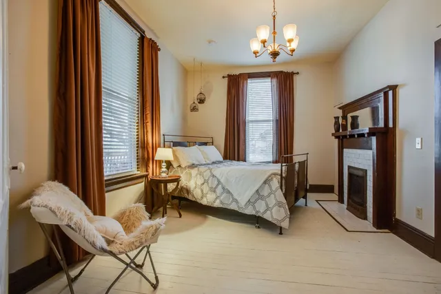 a bedroom with a bed and a chandelier