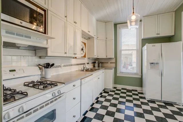 a kitchen with a sink stove and refrigerator
