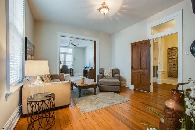 a living room with furniture and wooden floor