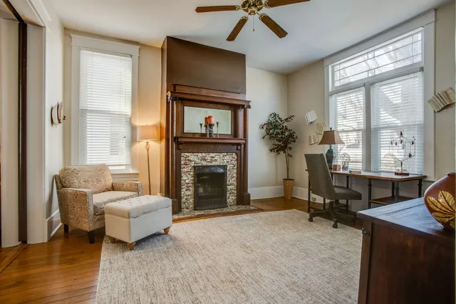 a living room with furniture a fireplace and a flat screen tv