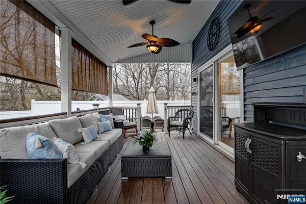a kitchen with stainless steel appliances granite countertop a sink a stove a microwave a refrigerator cabinets and dining table
