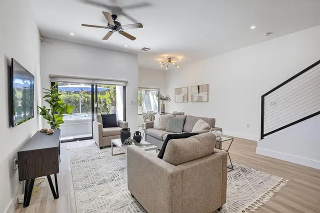 a living room with furniture and wooden floor