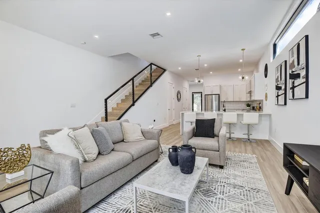 a living room with furniture and wooden floor