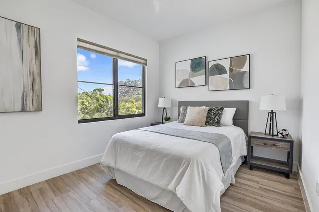 a bedroom with a bed and a mirror