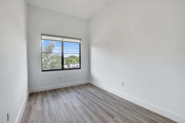 a view of a room with wooden floor