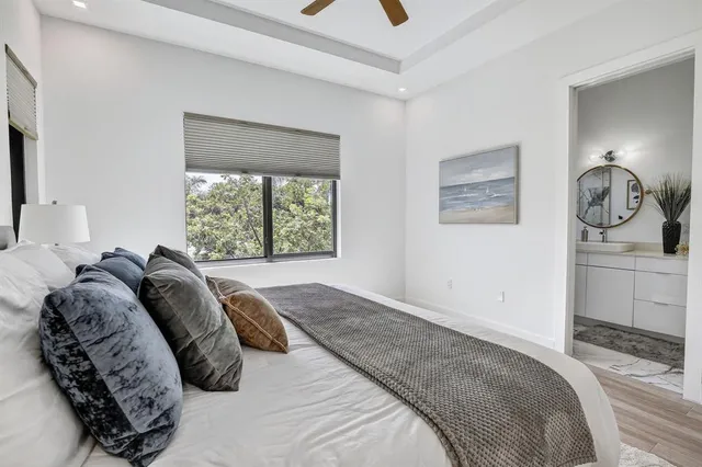 a bedroom with a bed and a window