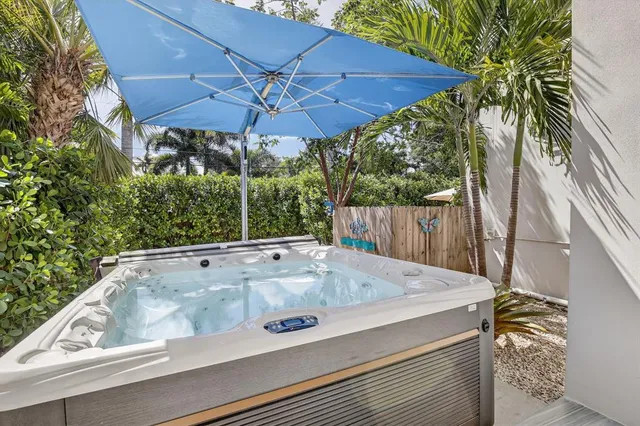 a view of a yard with plants and a bench