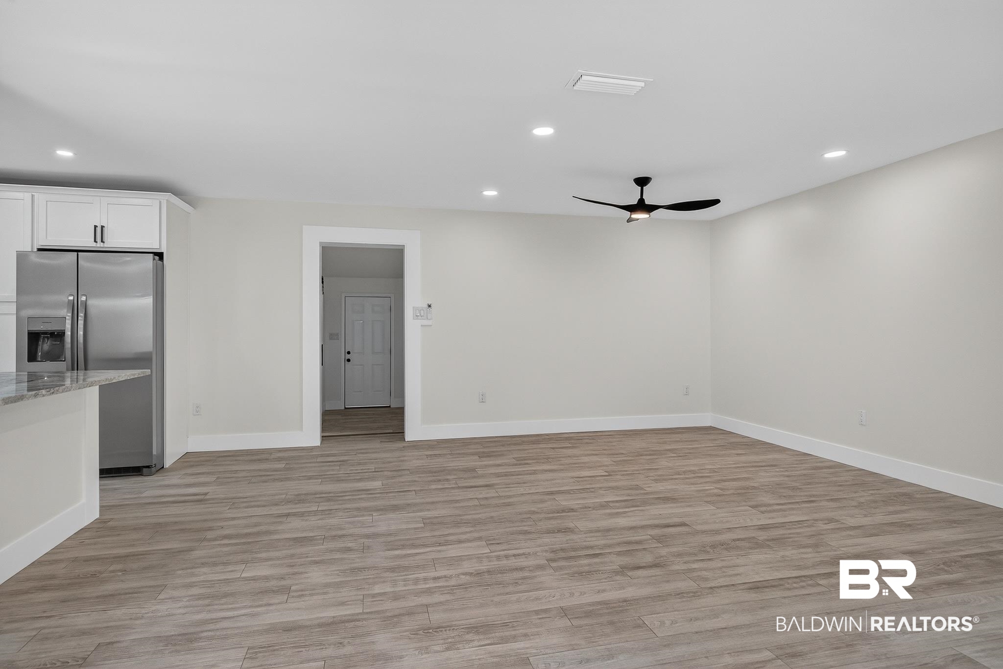 10650 Old Pascagoula Road Theodore, AL 36582 - Photo 15 of 77 Kitchen featuring stainless steel refrigerator with ice dispenser, light wood finished floors, white cabinets, a ceiling fan, and recessed lighting