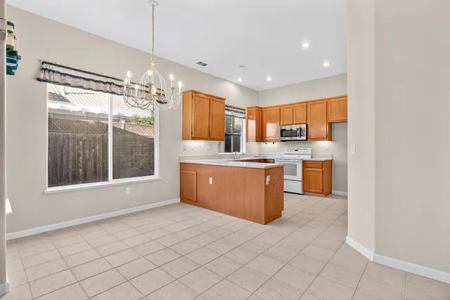 a kitchen with stainless steel appliances a sink window and cabinets